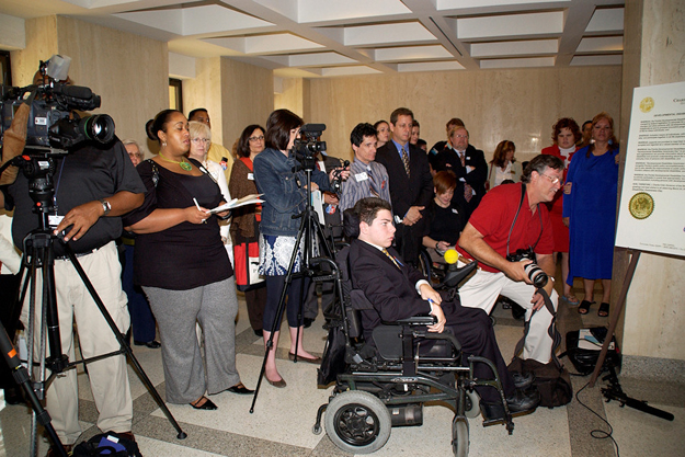 The DD Day news conference is packed with cameras, reporters, stakeholders, and individuals with disabilities