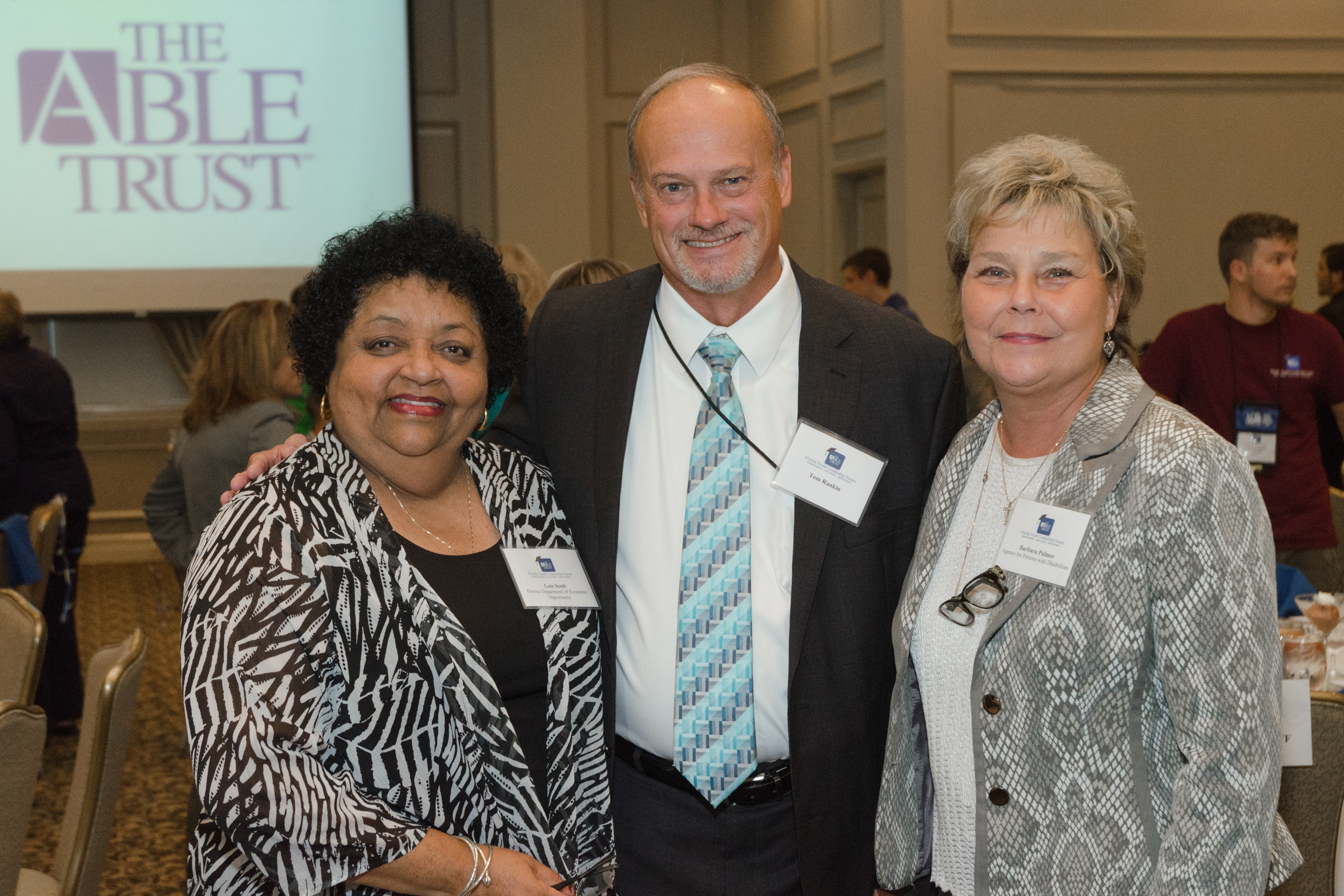 Lois Scott with the Department of Economic Opportunity, APD Deputy Director of Operations Tom Rankin, and APD Director Barbara Palmer.