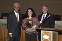 Governor Charlie Crist, left, and APD Director Jim DeBeaugrine present Area 2 employee Katie Bowman with the Supported Employee of the Year award