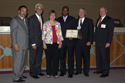 TJ Maxx's award presentation: from left, Tallahassee Mayor John Marks, Gov. Crist, Sarasota TJ Maxx Store Manager Linda Nunes, Davie TJ Maxx Store Manager Felix Julienne, APD Director Jim DeBeaugrine, and VR Director Bill Palmer