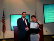 Area 15 Administrator Peter Karlan, left, presents a Certificate of Appreciation to APD customer John Phillips, who has been employed by a Publix supermarket in Vero Beach for ten years