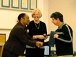 IRSC Dean of Minority Affairs Adriene Jefferson Dover, left, presents John Phillips with his award, assisted by VP of Instructional Services Mary Locke