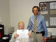 DMD participant and APD customer Felix Prado, left, accepts a DMD Certificate of Participation from his mentor for the day, Area 12 Administrator Ed De Bardeleben