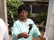 A participant learns how to feed a butterfly with Gatorade and a sponge brush at the Greathouse Butterfly Farm