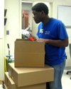 Lawrence Jones unpacks medical supplies---one of his duties as a respiratory care assistant at Baptist Hospital.  The eager, young employee has a disability