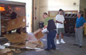 Jay Davis, second from right, Recycle Center director, talks about the operation at the loading dock with DeBeaugrine, right, while two Tacachale residents unload the center's truck after returning from its pickup run in Gainesville.
