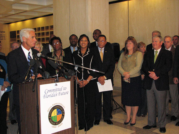 Gov. Charlie Crist delivers the keynote address at the celebration of the 40th anniversary of the Florida Commission on Human Relations. APD Director Jim DeBeaugrine, front row, right, is among the participating dignitaries