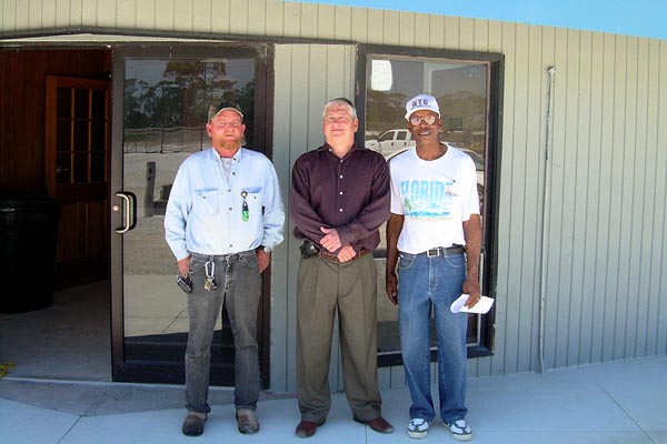Terry Franklin, Director Jim DeBeaugrine, and Park Manager Billy Quinn in front of one of the renovated park buildings