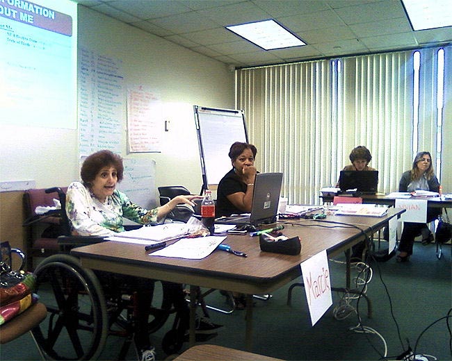Area 11 Trainer Marcie Brittain, left, and WSC Diane Gelpi, center, talk about the information that is needed in a new support plan during Person Centered Planning training in Miami