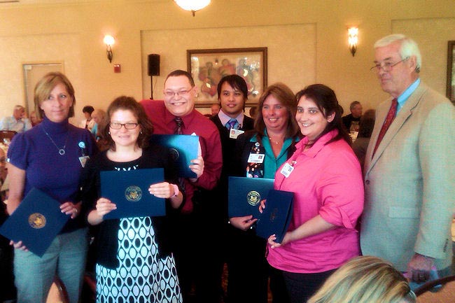 Pensacola Mayor Mike Wiggins, right, congratulates Project SEARCH participants during the Disability Summit Council Luncheon on October 4
