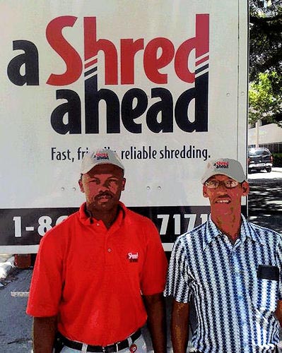 A Shred Ahead employee Manasse St. Fleur, left, poses with his new friend, APD customer Jorge Jaime. The pair shared a mentoring experience on July 19 at the APD Area 11 office in Miami