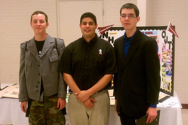 Navarre Kentucky Fried Chicken Manager Javier Silva, center, is pictured with Austin Hall, left, and Chase Rubinktwo of the students he hired to work in his restaurant. KFC partners with Navarre High School by providing students with disabilities with job placement opportunities