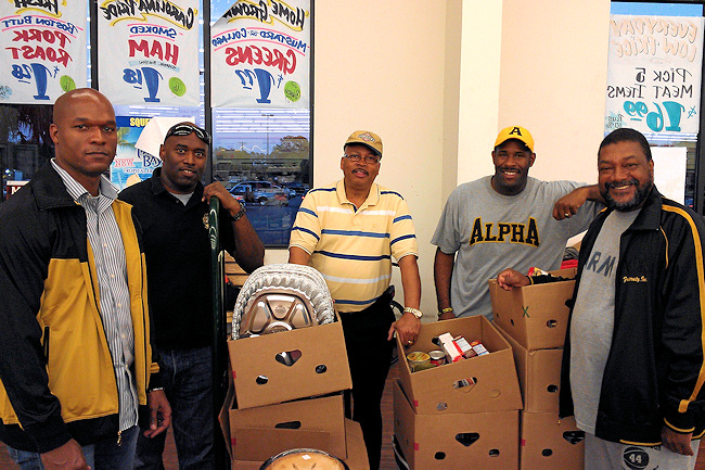 Members of Alpha Phi Fraternity team up with Roy More, operator of the Piggly Wiggly store in Quincy, to deliver Thanksgiving dinners to the families of APD customers in need. From left, Dr. David Clay; Warren Bowers; More; Octavius Jackson, chapter president and APD staff member; and Don White, chapter founder.