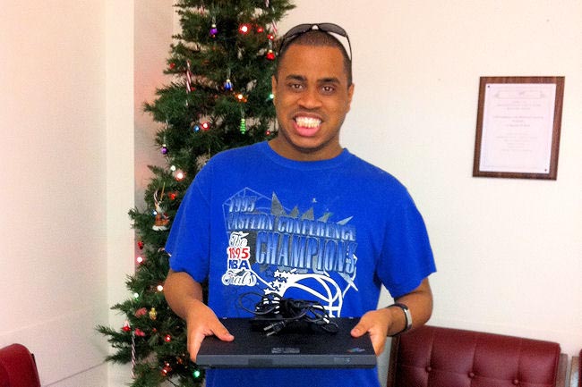 Area 12 customer Christopher LaCour can't hold back the joy when presented with his laptop