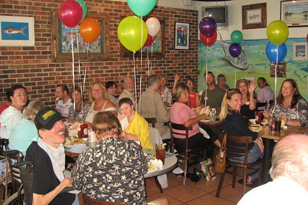 Mentors, mentees, and volunteers celebrate the success of DMD in Monroe County during a luncheon at Mangrove Mike's Café in Islamorada