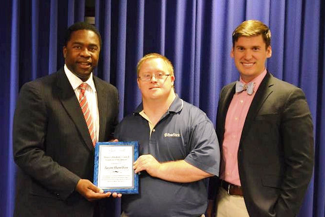 Jacksonville Mayor Alvin Brown, left, and Tyler Morris, right, chair of the Mayor's Disability Council, congratulate APD customer Jason Hamilton for being honored by EverBank with the Employee of the Quarter award.