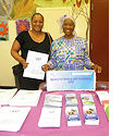 Jameela Abdul-Malik, right, provides a visitor with information about APD at the 10th Annual Community Resource Fair on May 2 in Fort Lauderdale.