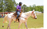 Sunland resident John Hines rides Pokie in the pole bending event during the 2012 Equestrian Show at Sunland Center on April 26. A few days later, Hines won a Gold Medal at the State Equestrian Championships in Tampa.