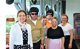 Elvis is still attracting the ladies, even when there are two impersonators in the house for the Central Office Ice Cream Social. They pose with some of the organizers of the event. From left, Darlene Golden, Art "Elvis" Barndt, Meghan Murray, Mike "Elvis" Holbert, Wilma Lefler, and Doria Moody.