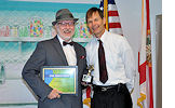 Director Mike Hansen, right, presents a STAR award to Duncan Hoehn.