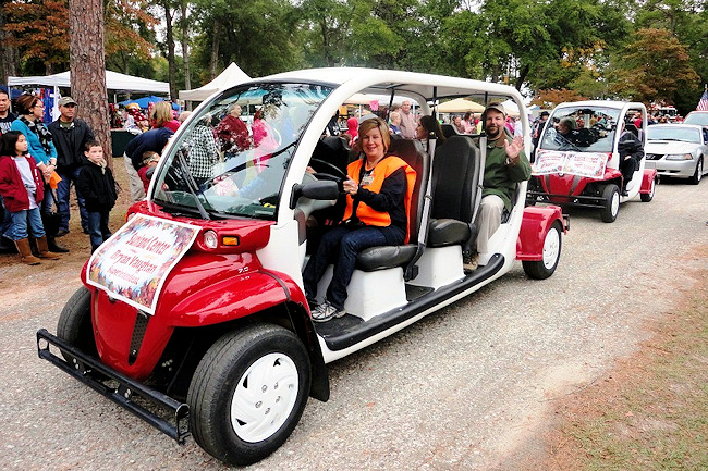 During last year's Fall Festival Parade at Sunland Center, Recreation Manager Karen Henrickson is at the wheel while Superintendent Bryan Vaughan waves to the crowd. Beside him is State Rep. Marti Coley (R-Marianna). The parade is part of Sunland's Fall Festival, which will be held this year on October 27. Y'all come!