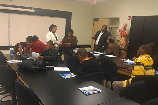 Rashaunda Grant sharing bus information with the group. 