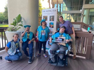 Royal DJs Ross, Jeremy, Jasmin, and Brandon, along with the Suncoast Region General Revenue Waiting List Supervisor Brett Gottschalk, pose for a photo while on break during a DJ gig for the Florida Association for Persons Supporting Employment First Conference.